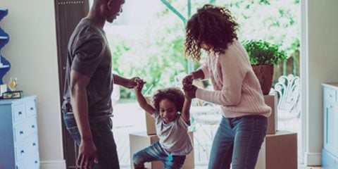 mother and father playing with their child