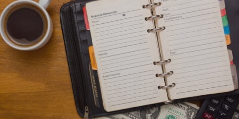 planner and coffee on table